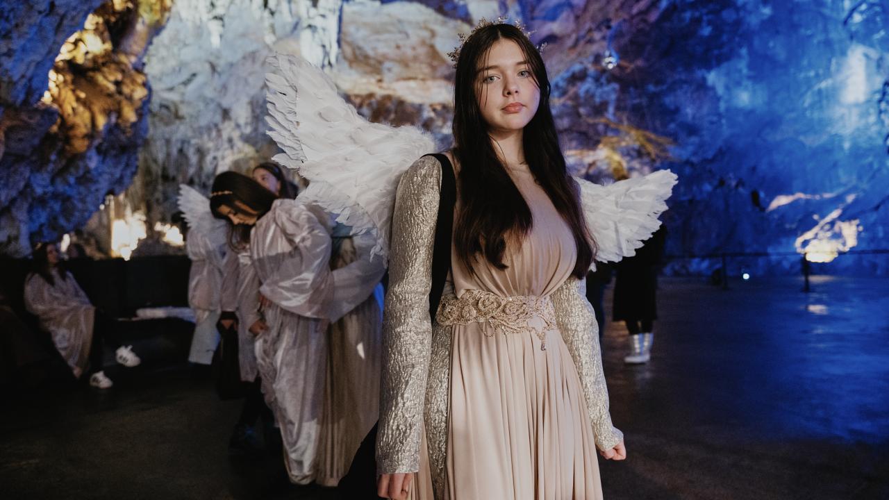 Young local artist in the role of an angel on rehersals for the premiere. Living Nativity in Postojna Cave 2025. Photo Ciril Jazbec